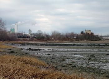 The shore and mudflats surrounding the GAC Chemical property on Kidder Point. An abandoned sulfuric acid plant visible at right is likely among contaminated areas addressed in a clean up plan the company submitted to Maine DEP this week. (Photo by Ethan Andrews)