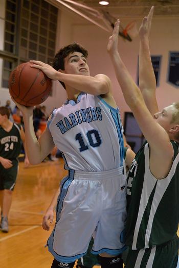 Oceanside’s Zach Davis, left, puts up a rebound over Mount View’s Colby Robbins. (Photo by Ron Hawkes)