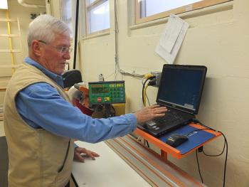Dick Cadwgan shows how the computer works to do precise cuts to the raw lumber minimizing waste to the smallest amount.