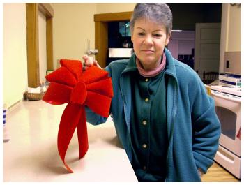 Dawn Voigt shows a hand-tied bow for a medium-sized wreath. Each one takes her 10-15 minutes to make. Over the past two weeks, she’s done more than 800 in a variety of styles and colors. (Photo by Ethan Andrews)