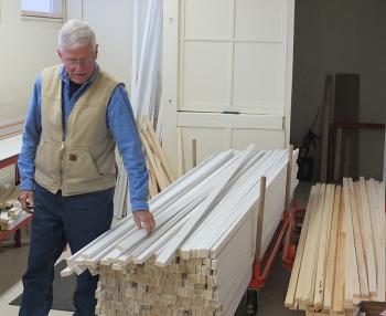 Dick Cadwgan shows the amount of wood to be sized and cut today for construction.