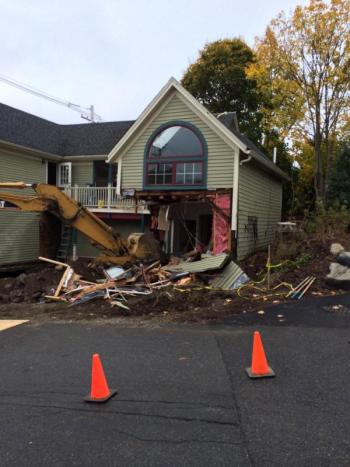 Tearing down the rotting decks and outbuildings. (Photo courtesy Brian Fitzpatrick)
