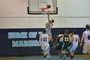 Oceanside’s Andrew King puts up a layup off a steal in the backcourt. (Photo by Ron Hawkes)