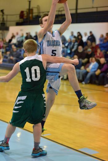 Oceanside’s Michael Norton, right, made a nice move on this layup attempt, but was called for the player control foul on Mount View’s Kalvin Croteau. (Photo by Ron Hawkes)