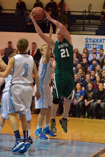 Mount View’s Nathan Wren, the lone senior on the team, goes past Walker Raney and up with a shot for two points. (Photo by Ron Hawkes)