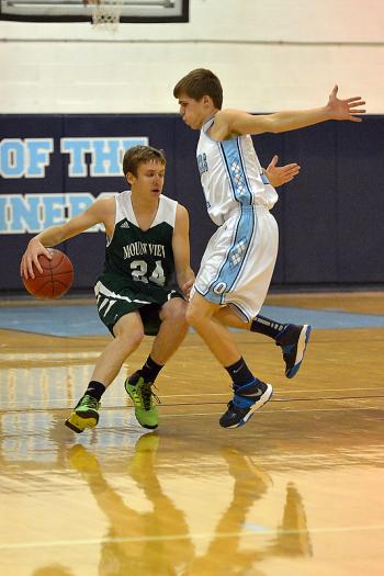 Oceanside’s Eli Thorbjornson, right, plays smart defense using his feet not his hands as Mount View’s Joey Danna tries to drive past him. (Photo by Ron Hawkes)