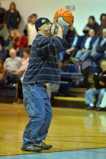 Chris Raye takes his third foul shot for The First at half time, making it to win a basketball which he kindly gave to a young lady that was more than ecstatic to receive it. (Photo by Ron Hawkes)