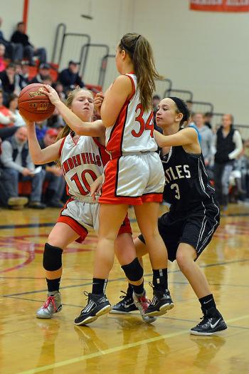 Camden Hills' Laticia Billings, left, tries to move as she gets caught up with teammate Emily Morse and Lincoln Academy’s Julianna Lafrenaye. (Photo by Ron Hawkes)