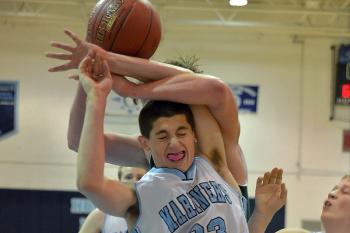 Oceanside’s Jarrod Leonardi gets tangled up with an unidentified Mount View player on this rebound giving Leonardi his fifth foul of the game. Oceanside won the game 74-48 to open the season. (Photo by Ron Hawkes)