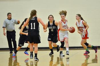 Camden Hills' Kira Barley’s hair is flying as she takes off after grabbing a rebound during Thursday’s game in Rockport. Lincoln Academy won the game 34-33. (Photo by Ron Hawkes)