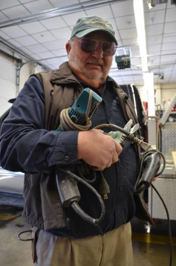 Rockport firefighter Allen Mitchell, who also owns a construction company, comes to the station loaded for bear. (Photo by Lynda Clancy)