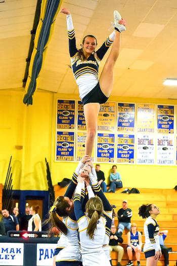 Medomak’s Stephanie Hill, top, one of the flyers, depends on the people below her to keep her safe. (Photo by Ron Hawkes)