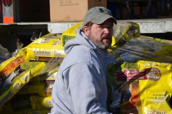 Joel Neal, Heidi’s husband, helps out unloading the food. (Photo courtesy Heidi Neal)