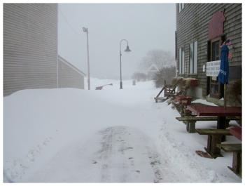 Winds left some spots, like this section of the Harbor Walk almost completely clear. In other spots, the snow drifted knee high. (Photo by Ethan Andrews)