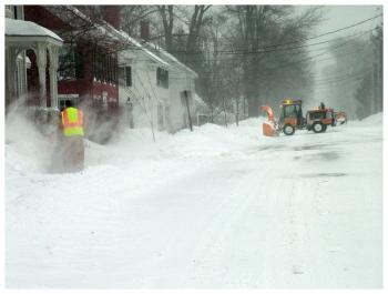 Workers clear the roadway and sidewalks on Church Street. (Photo by Ethan Andrews)