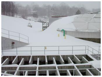Snow laps over the dome at the water treatment plant on Front Street. (Photo by Ethan Andrews)