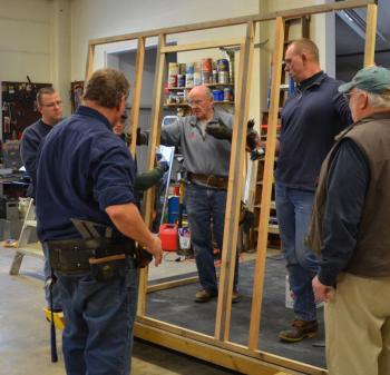 Phil Brown, Neal Bartley, Charlie Knight, John Wickenden and Allen Mitchell raise the first wall. (Photo by Lynda Clancy)