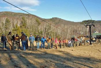 A mixed of volunteers and Snow Bowl staff worked Dec. 27 to splice the haul rope for the new triple chairlift. (Photo by Dave Ridley)