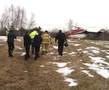 Greene first responders deliver 42-year-old Kenneth Bragdon of Greene Saturday afternoon to a LifeFlight of Maine helicopter, which transported him to Central Maine Medical Center. (Courtesy Maine State Police)