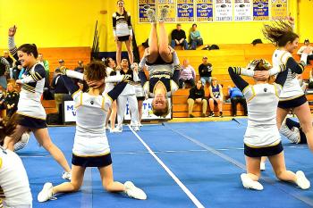 Cassidy Dever, center, flies out with some outstanding tumbling to get the crowd into the routine. (Photo by Ron Hawkes)