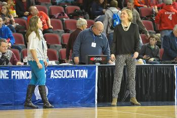 Two outstanding alumni players from Camden Hills, now coaching rival teams, Meg Cressler, right at Camden Hills and Samantha Wiley, at Oceanside share a laugh before the game. (Photo by Ron Hawkes)