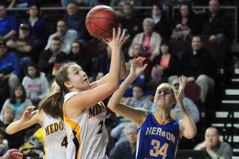 Medomak Valley’s Hannah Heald (24) pulls a rebound away from Hermon's Emi Higgins in the Feb 13 game. (Courtesy of Skip Hawkes/mainesportsreport.com)