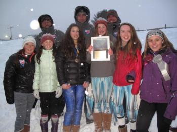 The Camden Snow Bowl middle school girls ski state champions! Front row, from left, are Courtney King, Isabelle Manahan, Vika Santoro, Sydney White, Annabelle Williams and Jesi Mann, as well as their coaches. Missing from the photo are Molly McClellan and Ella Ardizoni. The coaches are, from left, Mike Bridges, Weber Roberts and Mike White. (Courtesy Lori Traikos)