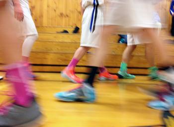 The boys on Searsport’s varsity basketball squad have mostly ditched “team shoes” in favor of bright colors. These got an extra boost at a Feb. 5 home game, pictured, when the team added pink socks and laces for breast cancer awareness. (Photo by Ethan Andrews)