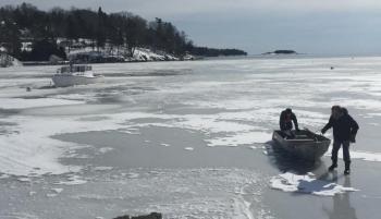 The ice was thick enough in Rockport Harbor Feb. 18 to slide a skiff out to LaBoat III. (Photo courtesy Abbie Leonard)