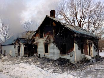 A Swanville house that caught fire Monday continued to smolder Tuesday morning despite a multi-town firefighting effort through much of the night. (Photo by Ethan Andrews)