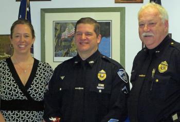 From left, Heidi Neal, her husband, Rockland Police Detective Joel Neal, and Chief Bruce Boucher. (Courtesy Rockland Police Department)