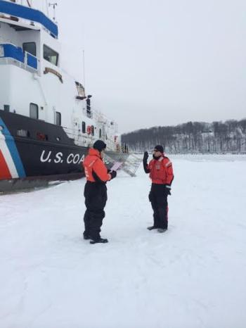 Lt. Bender administers the reenlistment oath to Boatswain's Mate First Class George Ramirez, Operations Petty Officer, on the river ice March 1. (Photo courtesy U.S. Coast Guard)