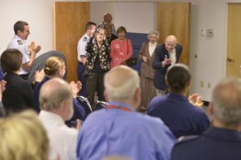 Linwood ‘Tick’ Thumm takes a bow to a round of applause at the Portsmouth Federal Building in Portsmouth, Va., March 26, 2015. Thumm, a World War II Coast Guard veteran, had just turned 100 and was celebrating with fellow Coast Guard members and civilians. (U.S. Coast Guard photo by Petty Officer 3rd Class David Weydert)