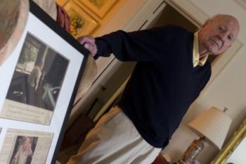 Linwood ‘Tick’ Thumm displays a newspaper article from the Virginian Pilot recognizing him for his service to the Virginia State parks, while at home in Norfolk, Va., March 11, 2015. Thumm, a former officer in the U.S. Coast Guard, worked as a volunteer park ranger at First Landing State Park in Virginia Beach. (Courtesy U.S. Coast Guard)