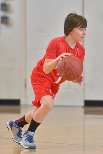Thomaston’s Justin Hurley clears the ball out after pulling down a rebound. (Photo by Ron Hawkes)