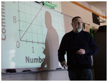 Dennis Nardone reviews a question about probability with his seventh-grade math class. (Photo by Ethan Andrews)