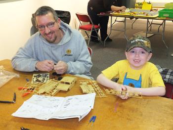 Jason & Lucas Baker, 6, of Washington, take advantage of the free workshop to build a model.