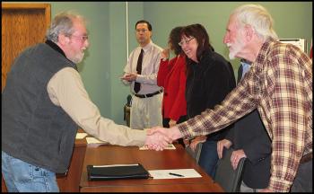 William O’Brien, Airport Maintenance Supervisor, is congratulated by commissioner Rick Parent Jr.
