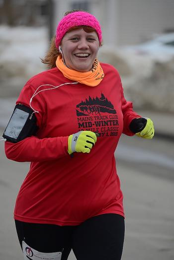 Jody Dinsmore of South Thomaston is all smiles as she passes by on the way to the finish line. (Photo by Ron Hawkes)