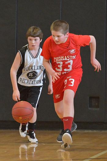 Thomaston’s Christian Weed, right, is out in front of Rockland’s Hunter Norton for a loose ball. (Photo by Ron Hawkes)