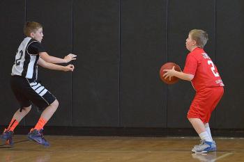 Thomaston’s Darik Johnson, right, gets set for a shot while Rockland’s Tyler Sukeforth tries to get out and guard him. (Photo by Ron Hawkes)