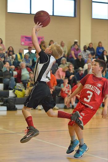 Rockland’s Zepherin Leppanen, left, goes up with a shot in front of Thomaston’s James Day. (Photo by Ron Hawkes)