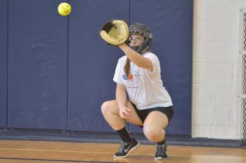 Oceanside’s Madelyn Young does some catching during warm ups Thursday. (Photo by Ron Hawkes)