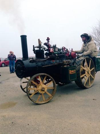Jake Swift takes a spin in the Rumley steam tractor. (Photo from OHTM).