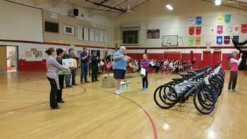 Ella Ryan, who was the top reader with 28 books receives a special award from Jeff Sukeforth. Photo by Sarah Shepherd