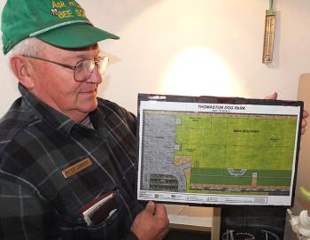 Peter Lammert displays the park layout.
