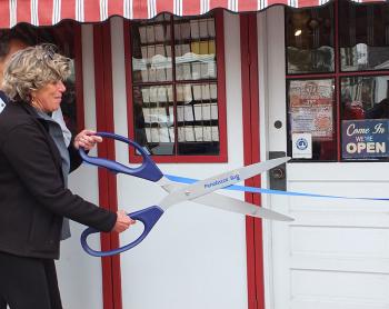 Meg Quijano cuts the ribbon to open the store for its 75th year.