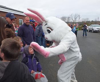 The Easter Bunny high fives the kids after his arrival.