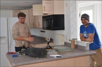 Chris Pinchbeck and Andrew Stewart. Chris is Andrew’s friend, brother-in-law, and general contractor. In early April, they were tearing out the kitchen of the Good House, now destined to be the Drouthy Bear. (Photo by Lynda Clancy)