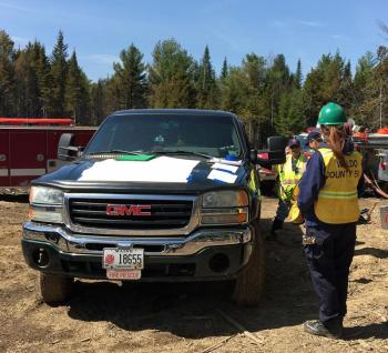 Gayle McKeige (back to the camera) was accountability officer and provided emergency medical services at the fire scene in Searsmont on EMA Incident Management Assistance Team. (Photo by Holly S. Edwards)